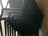 a lot of chairs that are stacked up against the wall