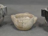three stone bowls sitting next to each other on a table