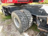 a large truck with a big tire on the back of it