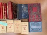 several books are lined up on a table next to each other