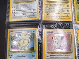 four different pokemon cards are in plastic bags on a table