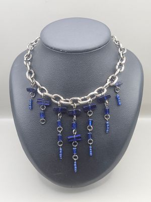 a close up of a necklace on a mannequin with blue beads