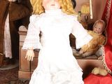 a doll that is sitting on a table with other dolls