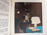 a picture of a book with a picture of a man sitting at a desk