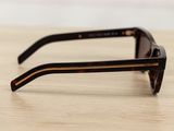 a close up of a pair of sunglasses on a wooden table