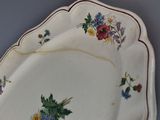 a white plate with flowers on it on a table