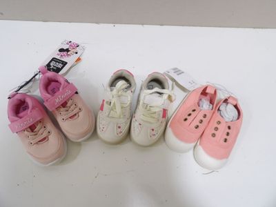 several pairs of baby shoes are lined up on a white surface