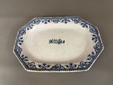 a close up of a blue and white plate on a table