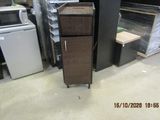a tall cabinet in the middle of a room filled with appliances