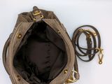 an image of a brown purse with a brown handle and a brown strap