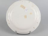 underside view of a white plate with a design on the rim