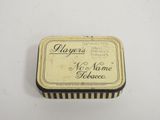 an old tin box with a name on it sitting on a table
