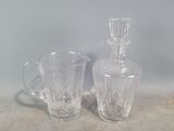 two glass vases sitting next to each other on a table