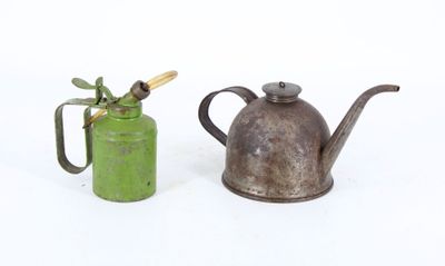 two old teapots sitting next to each other on a white surface