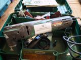 a green box filled with assorted tools on the floor