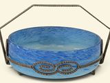 a blue bowl sitting on a metal stand with a handle