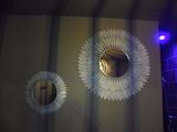 two mirrors hanging on the wall in the bathroom