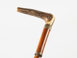 an old wooden walking stick with a metal handle on a white background