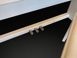 a white piano sitting next to a white bench