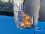 a close up of a car ' s side mirror with a reflection of a building in the background