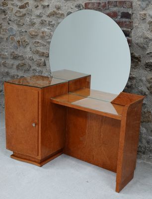 COIFFEUSE ouvrant à un vantail et surmontée d'un miroir circ…