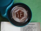 a coin sitting on top of a piece of paper on a table