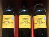 three bottles of wine are in a box on a table