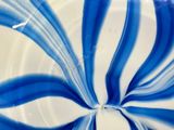 a blue and white swirl on a white plate