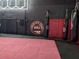a gym area with boxing mats and punching bags