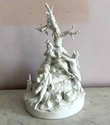 a statue of a group of people sitting on a table