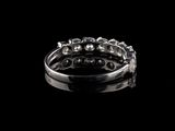 a close up of a silver ring on a black background