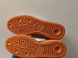 a pair of shoes that are on top of a blue box