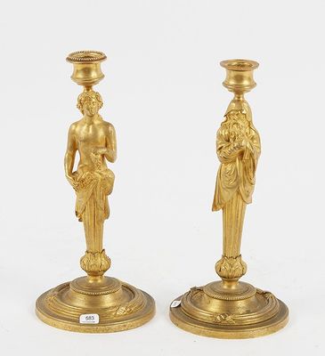 pair of antique brass candlesticks with figures on bases