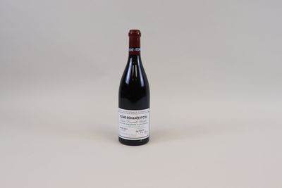 une photo d'une bouteille de vin posée sur une table