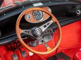 a steering wheel and dashboard of a red sports car