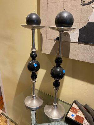 two candles that are sitting on a glass table