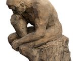 statue of a man sitting on a tree stump with his head in his hands