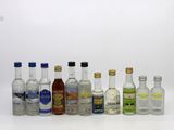 several bottles of alcohol are lined up on a white surface