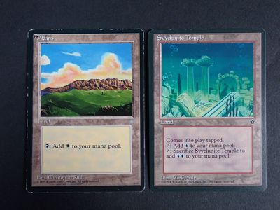 the two cards have a picture of a city and a mountain