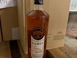 a bottle of wine sitting on a table next to a box