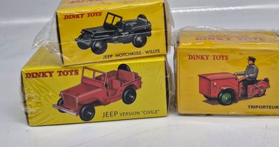 three boxes of toy vehicles are sitting on a white surface