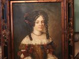 a painting of a woman in a brown dress sitting on the floor