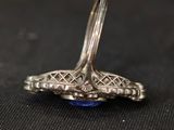 an image of a ring with a blue stone in the middle