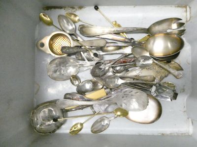 a lot of silver spoons and spoons in a white box