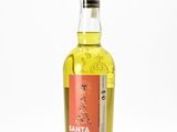 a bottle of tequila sitting on top of a white surface