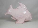 a pink fish shaped object on a white surface