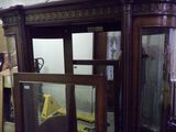 a large wooden cabinet with a mirror in it
