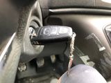 a car key that is attached to the steering wheel of a car