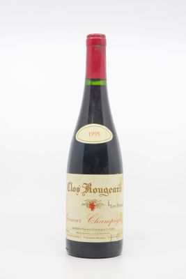 a close up of a bottle of wine on a white surface