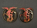 a pair of red and gold brooches depicting a man and a woman